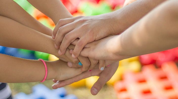 utsträckta händer som lagts på varandra.