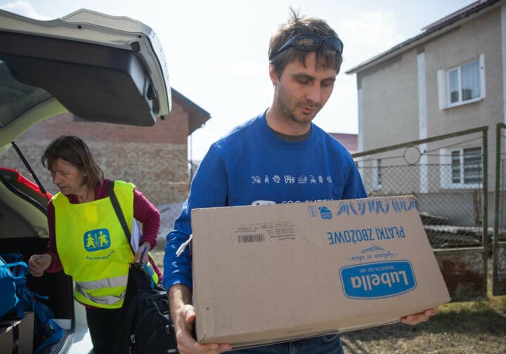 Medarbetare som bär på en låda.